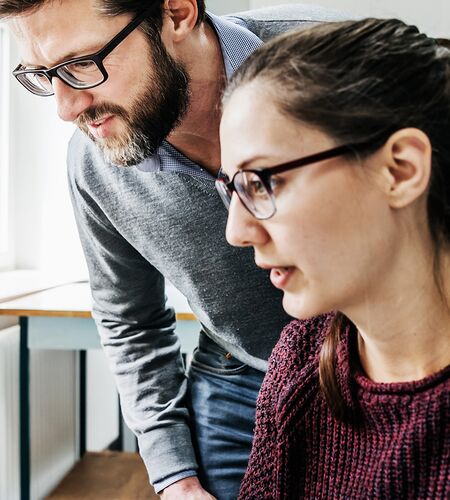 Drei Techniker:innen im Austausch bei der Arbeit