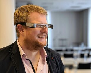 lächelnder Mann mit Augmented-Reality-Brille