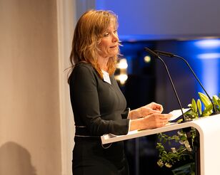 Absolventenrednerin Irene Wert steht an Rednerpult und spricht.